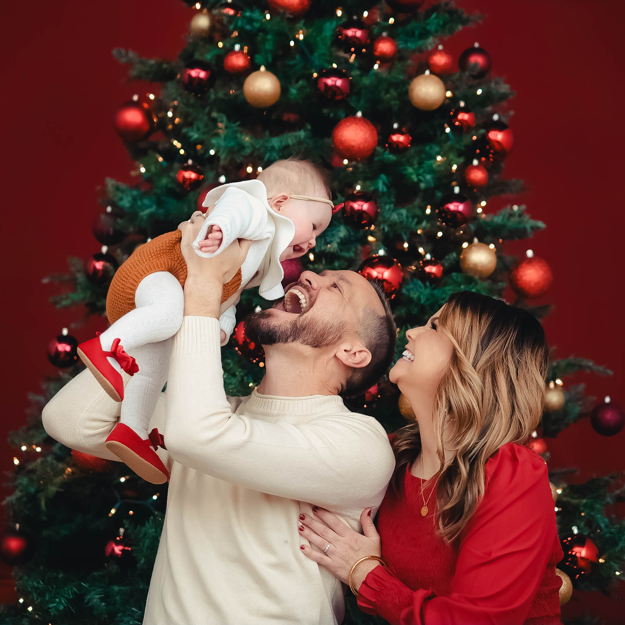 Family by the Christmas tree