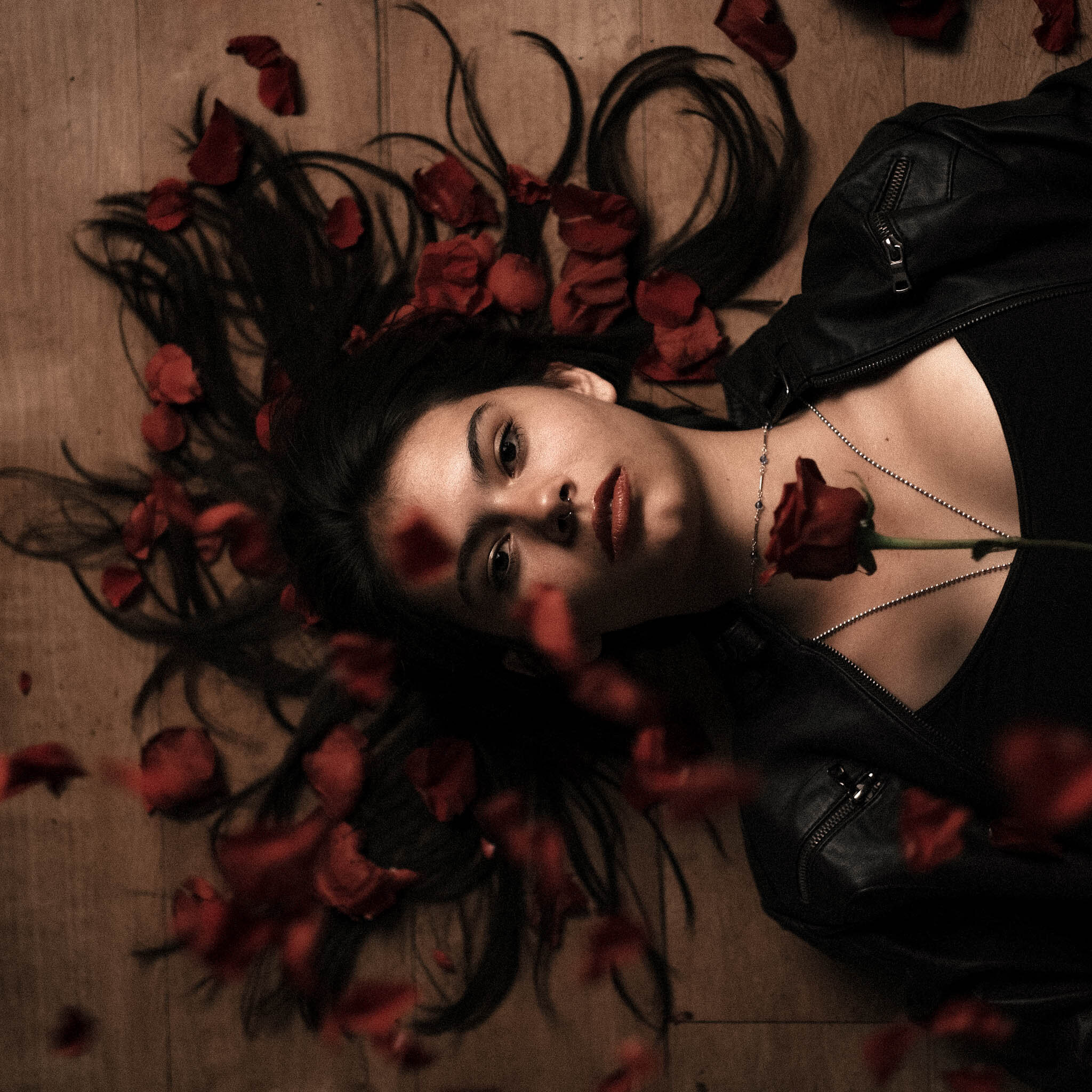 Dramatic portrait surrounded by dark florals
