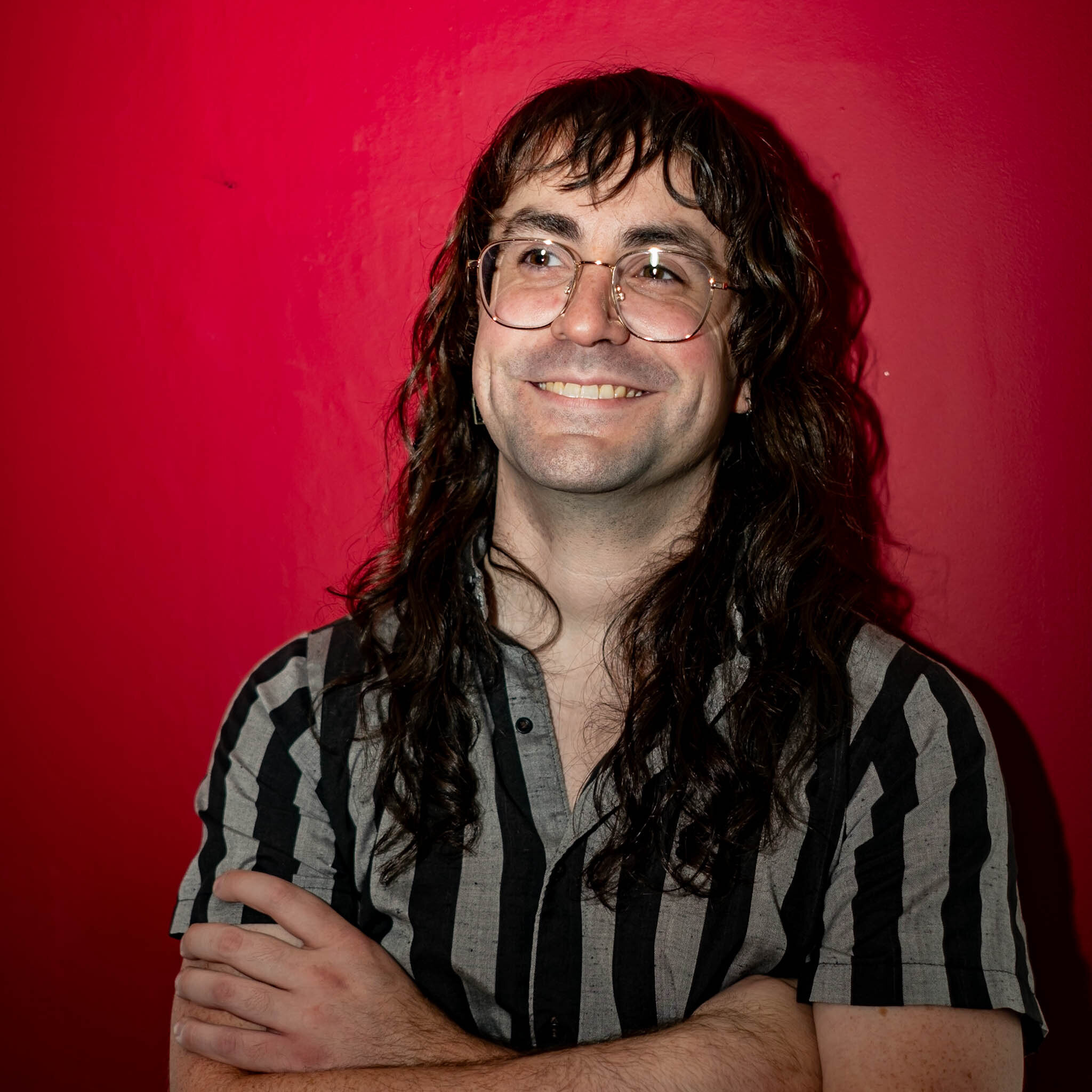 Portrait against red studio backdrop